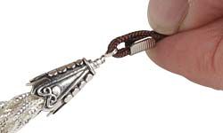 Cord attached to wire on top of chain tassel